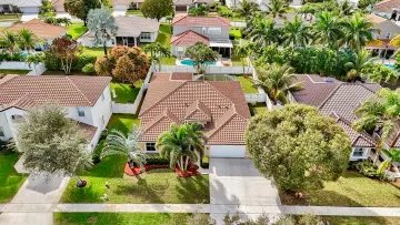 Aerial view of the home and its screened patio among neighboring houses in Winston Trails