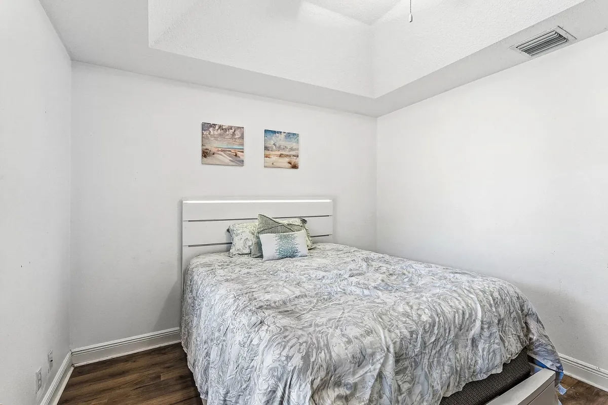 Bedroom with vaulted ceiling and neutral finishes