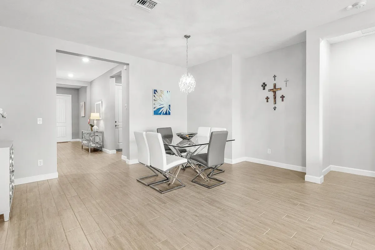 Dining area with pendant lighting, open to the entry and living space