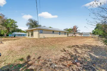 Side view of the home across its wide open yard
