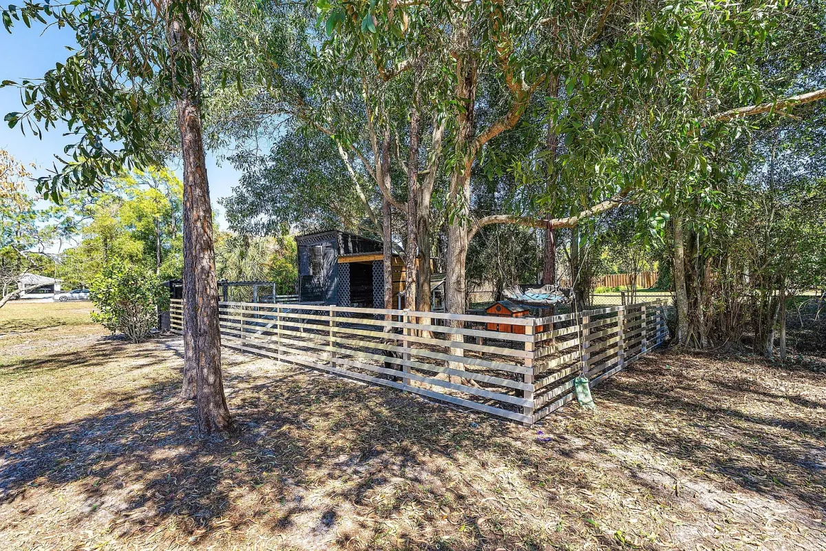 Fenced area at the rear of the lot under mature trees