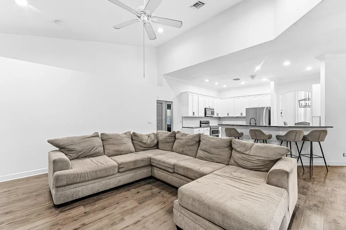 Great room with vaulted ceiling and sectional seating, open to the kitchen