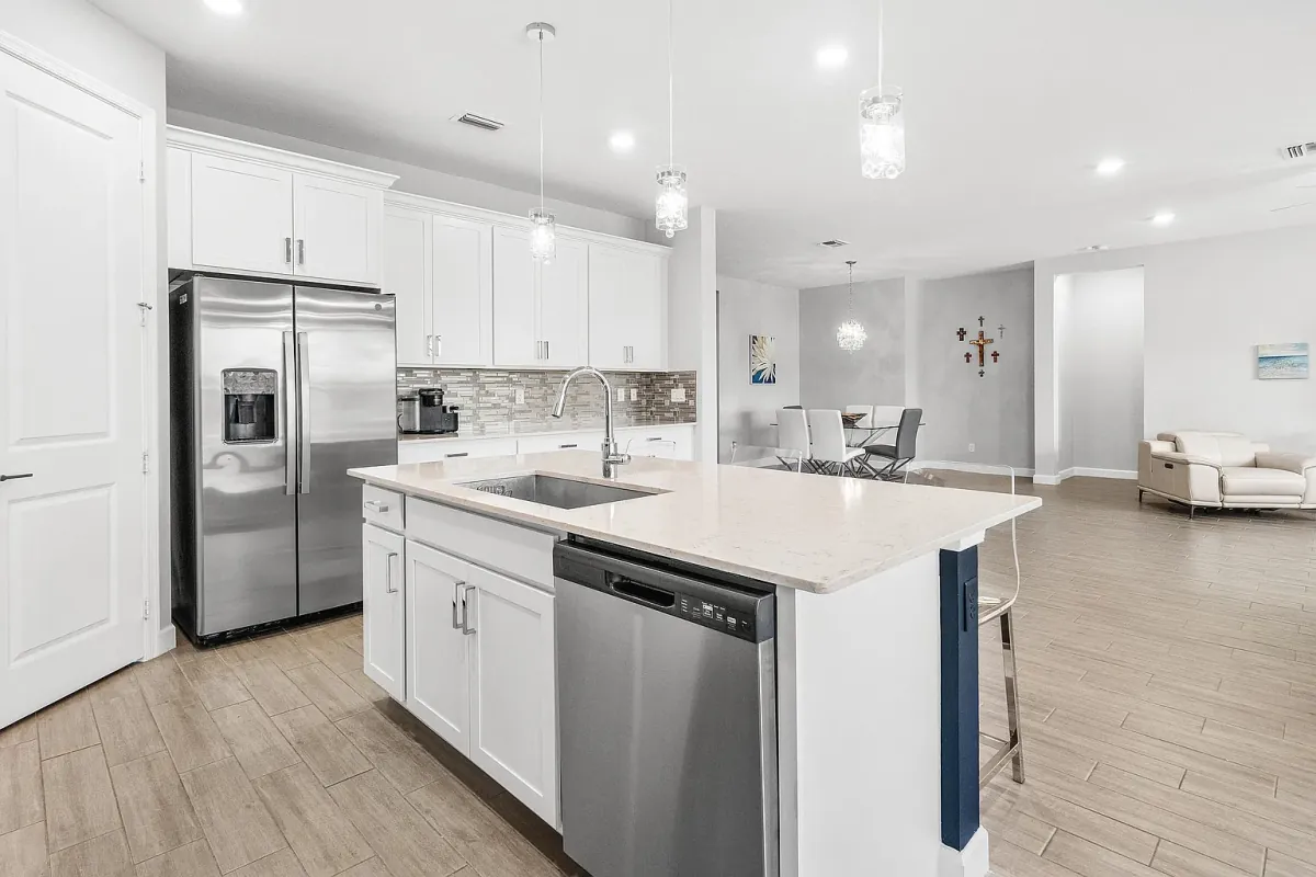Kitchen island with sink and dishwasher, open to the living area