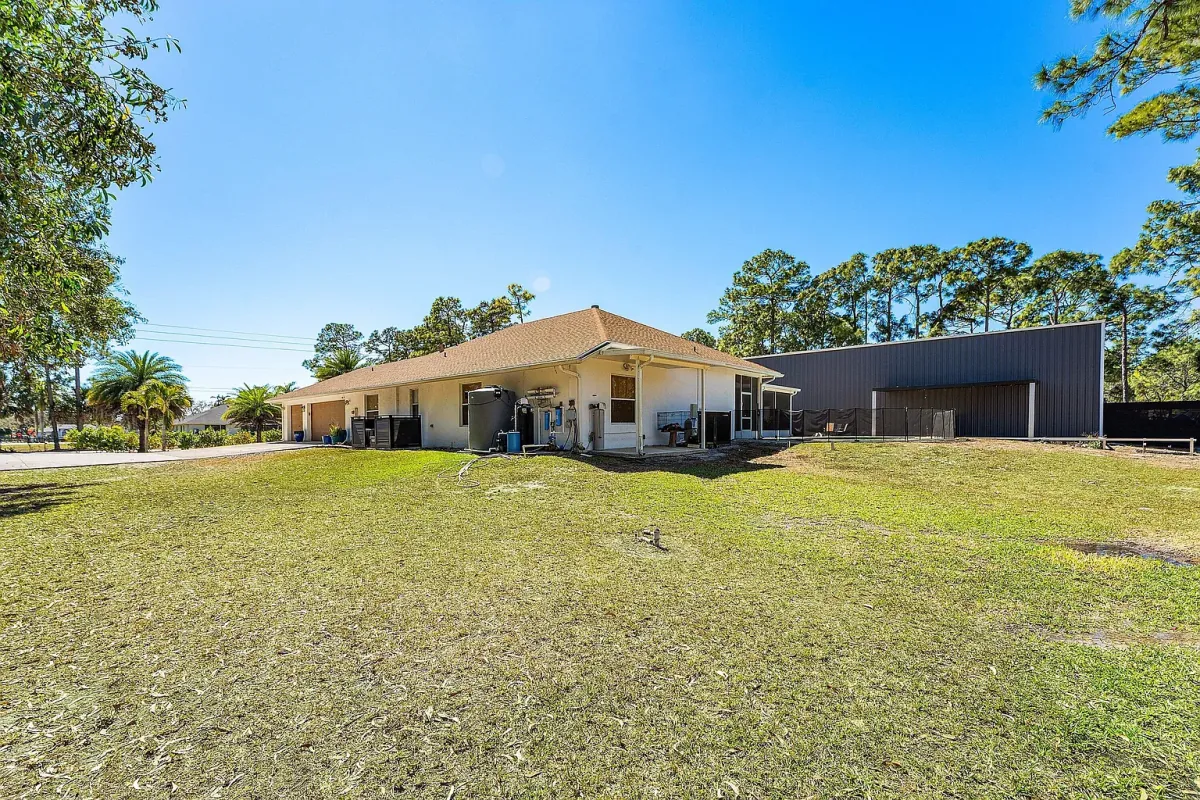 Rear elevation of the home seen from across the open lawn