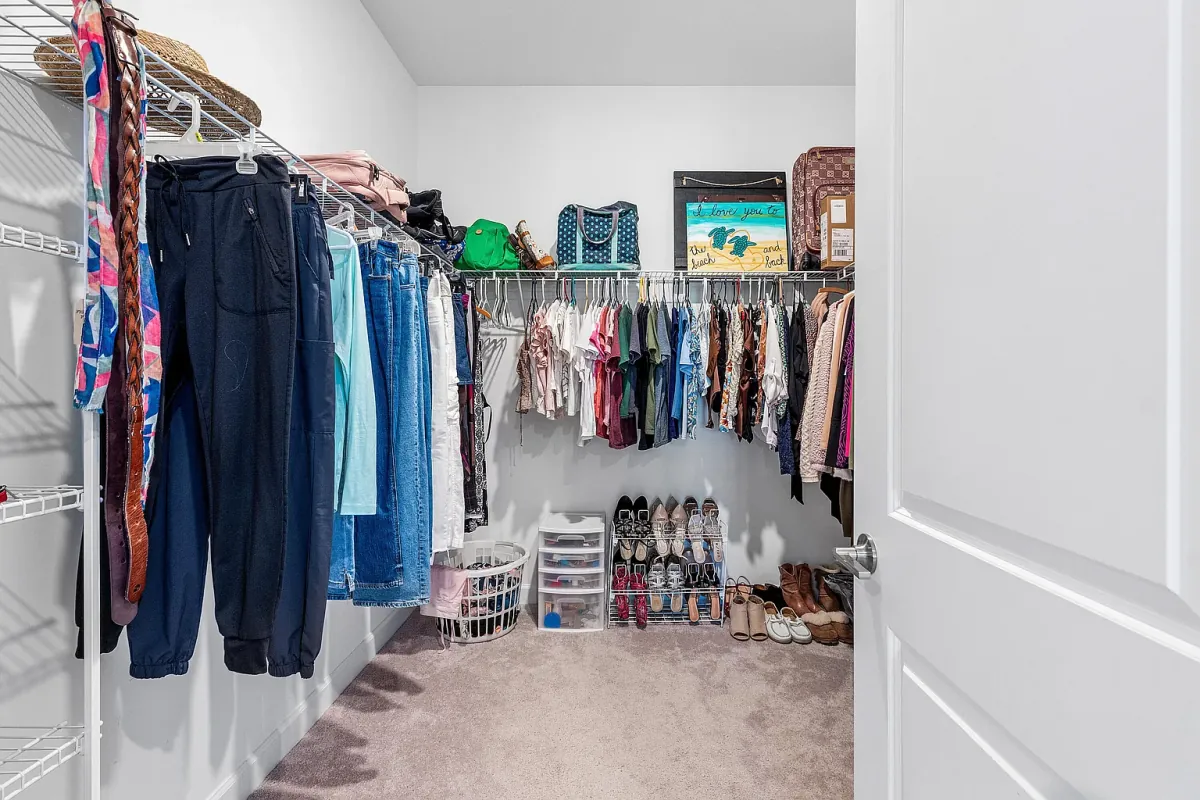 Walk-in closet with full-length hanging space and built-in shelving