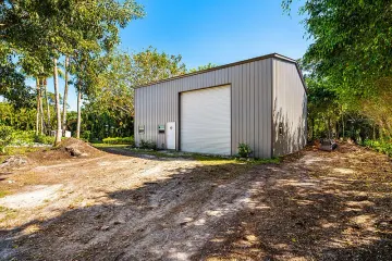 The 40 by 40 foot metal workshop with a roll-up door